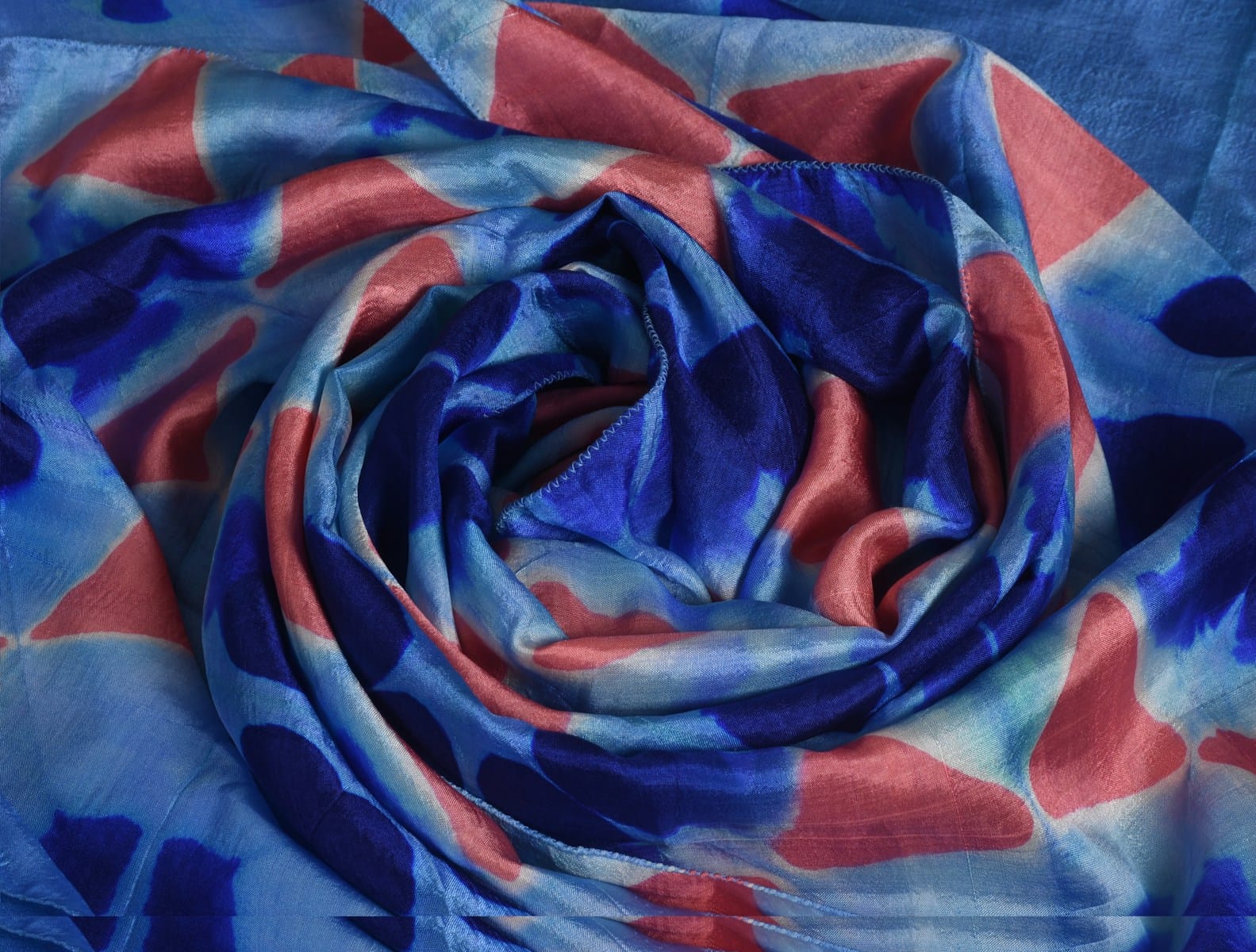a blue, red, and white scarf with a design on it