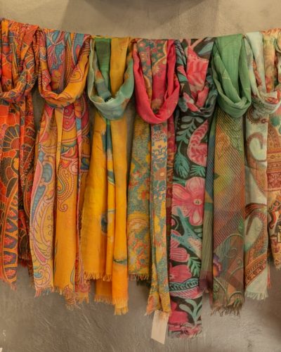a bunch of scarves hanging on a clothes line